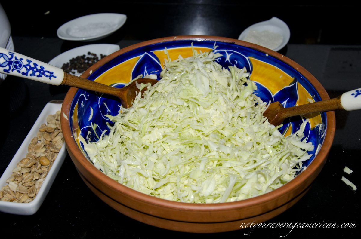 Toss the sugar, salt, and lime juice with the shredded cabbage.