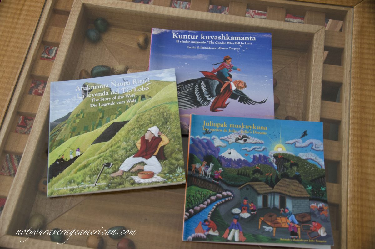Three books with artwork from Tigua by the Toaquiza family.