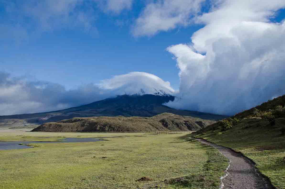 View of Cotopaxi with incoming clouds; Laguna Limpiopungo, Cotopaxi National Park, Ecuador