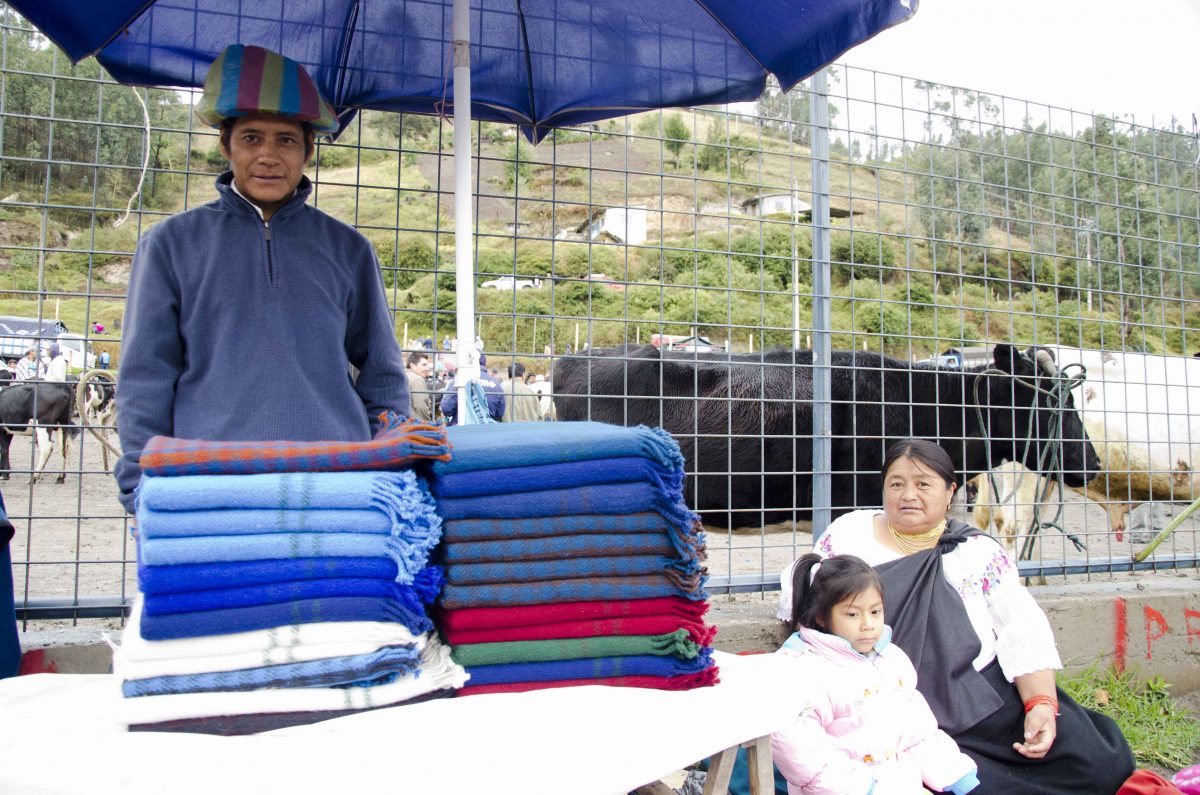 Vendedor de mantas y familia en el mercado de animales, Otavalo, Ecuador | ©Ángela Drake