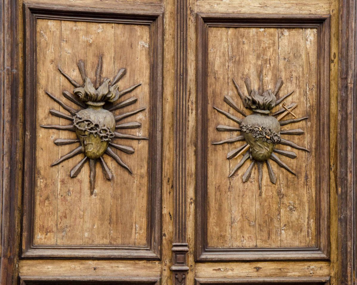 Carved wooden doors to the Iglesia de Todos Santos, Cuenca, Ecuador