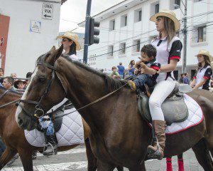 Mom and baby riding a dark brown horse