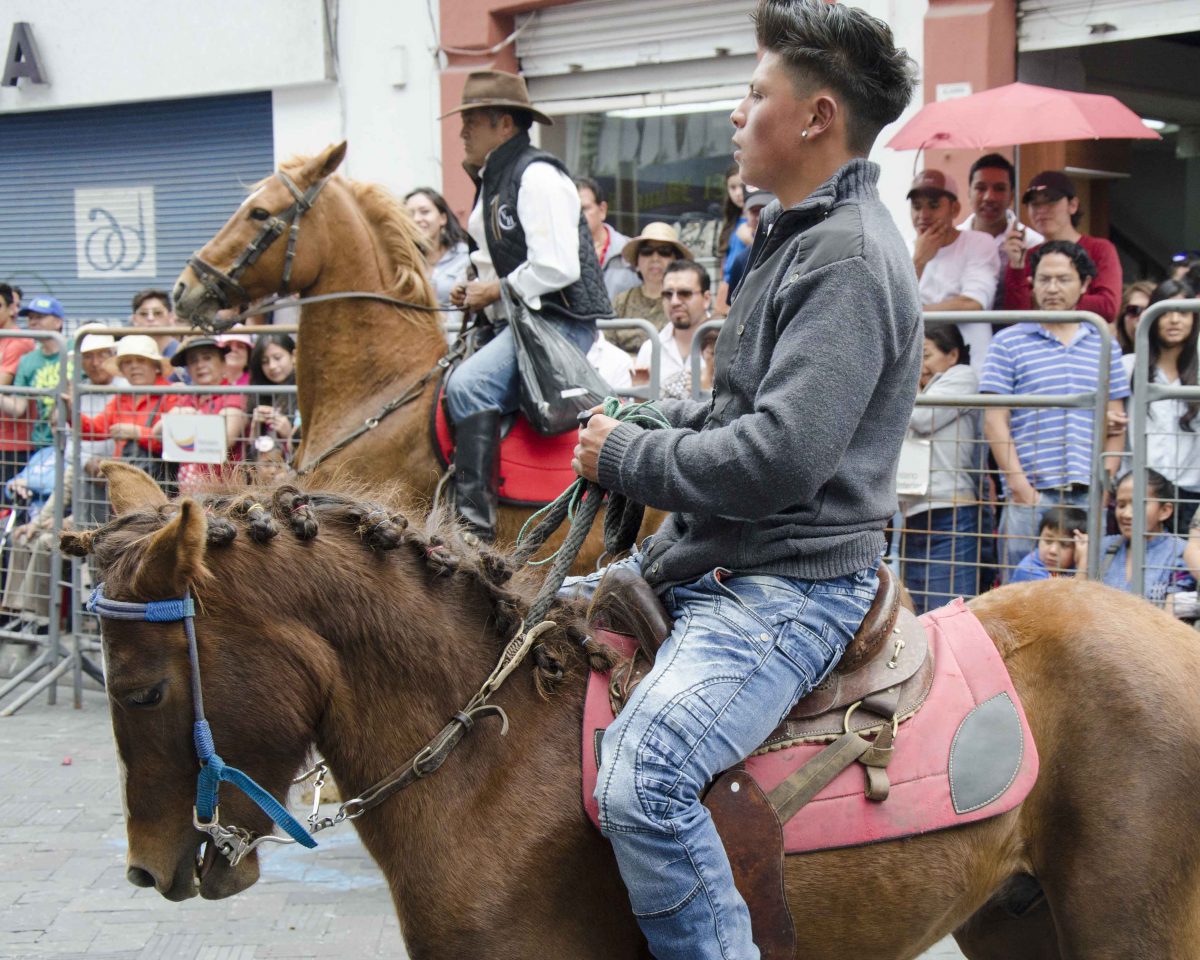 A young man and his horse in the Cacería del Zorro Parade, Ibarra, Ecuador | ©Angela Drake