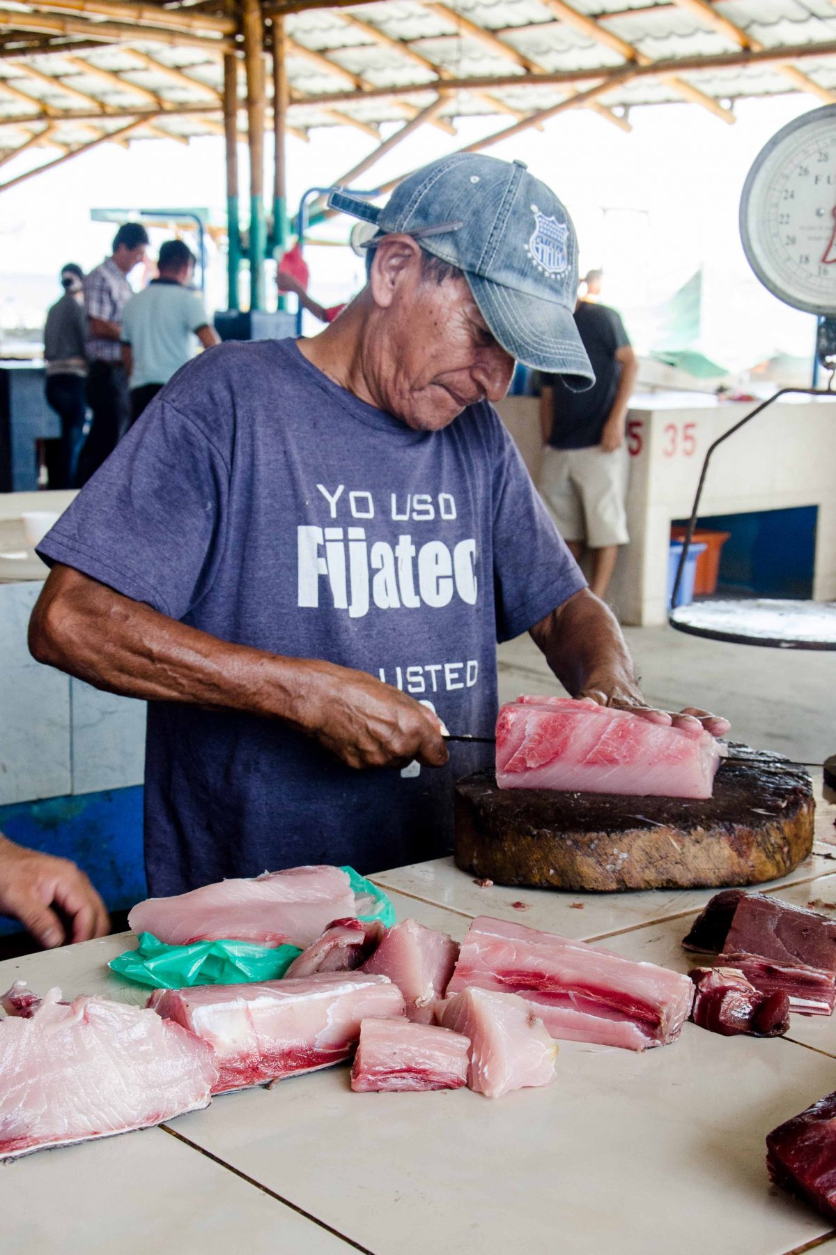 Slicing freshly caught tuna at the market in Manta, Ecuador | ©Angela Drake / Not Your Average American