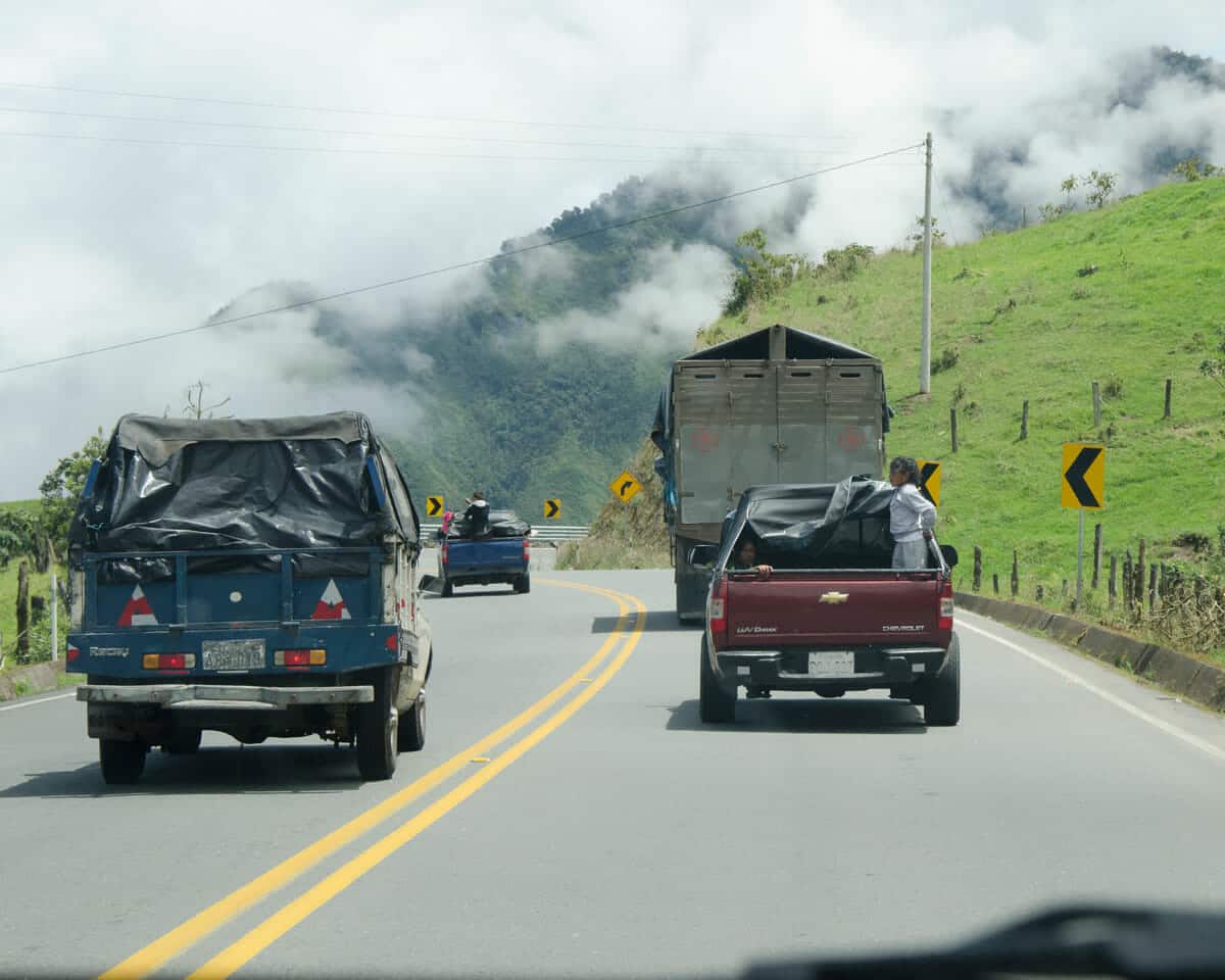 Several cars passing on a curve in Ecuador | ©Angela Drake