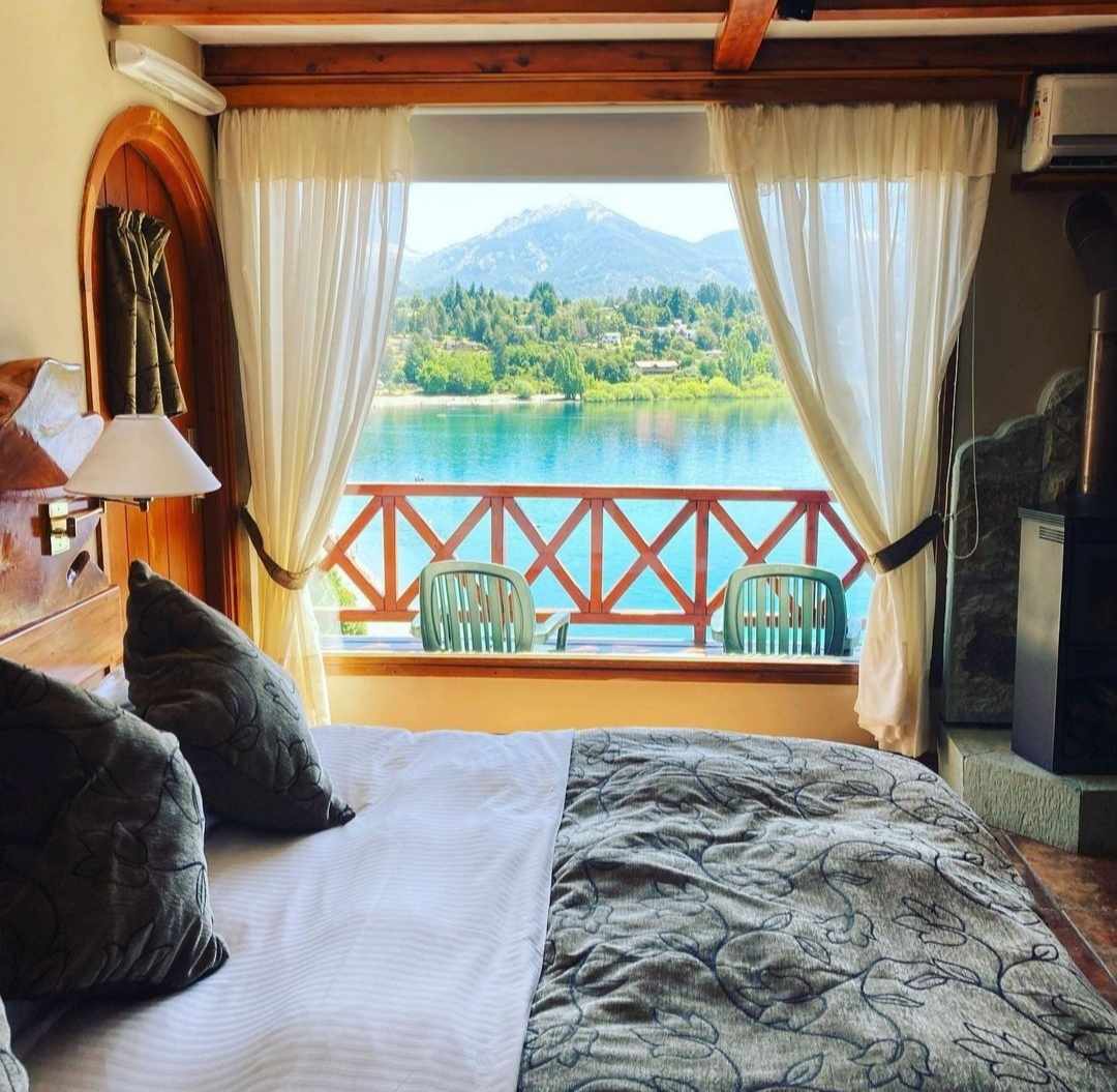 Room at the Charming Luxury Lodge and Private Spa Double bed in room with view of Lake Nahuel Huapi