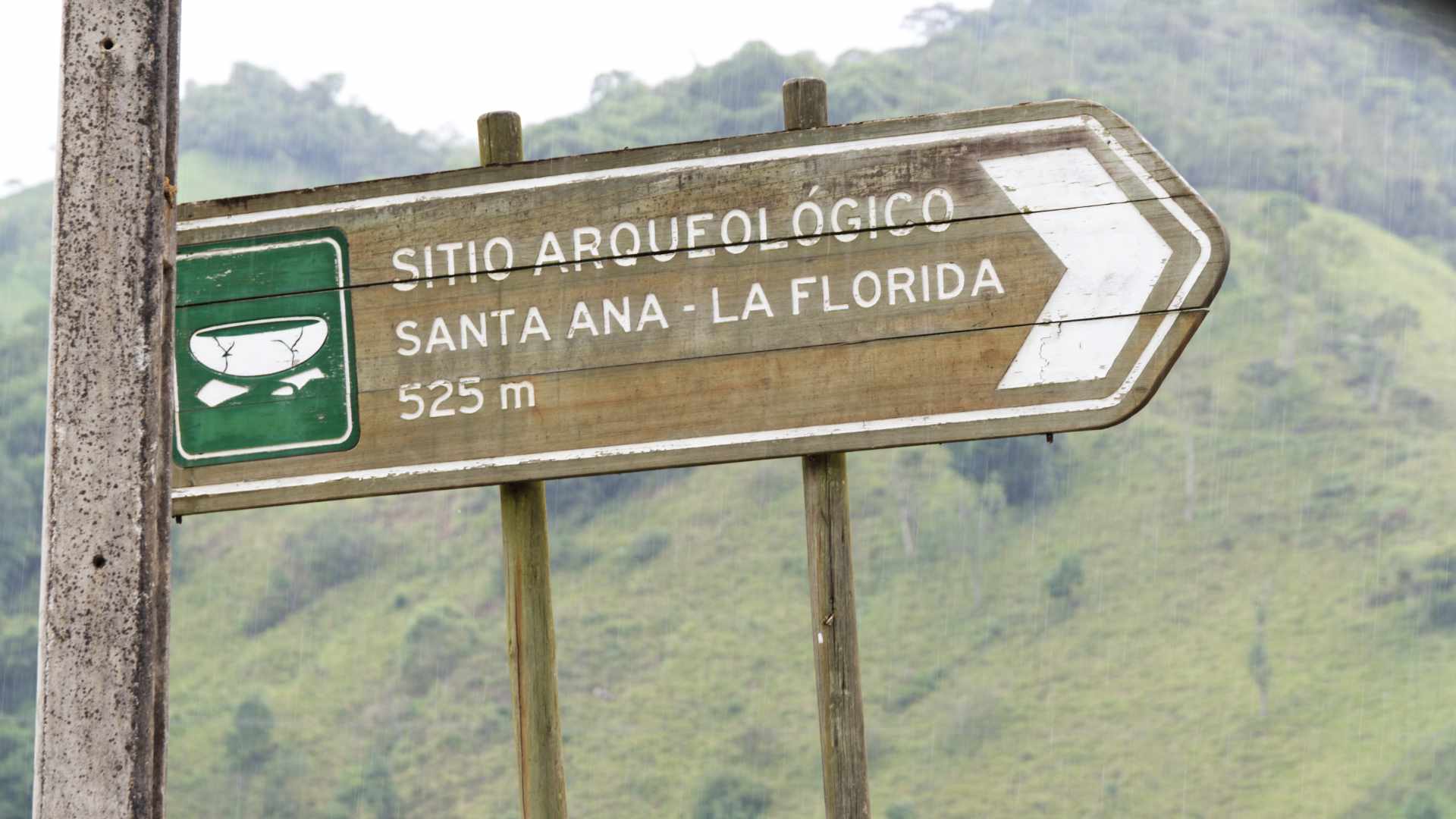 Wooden Road Sign pointing to an archeology site