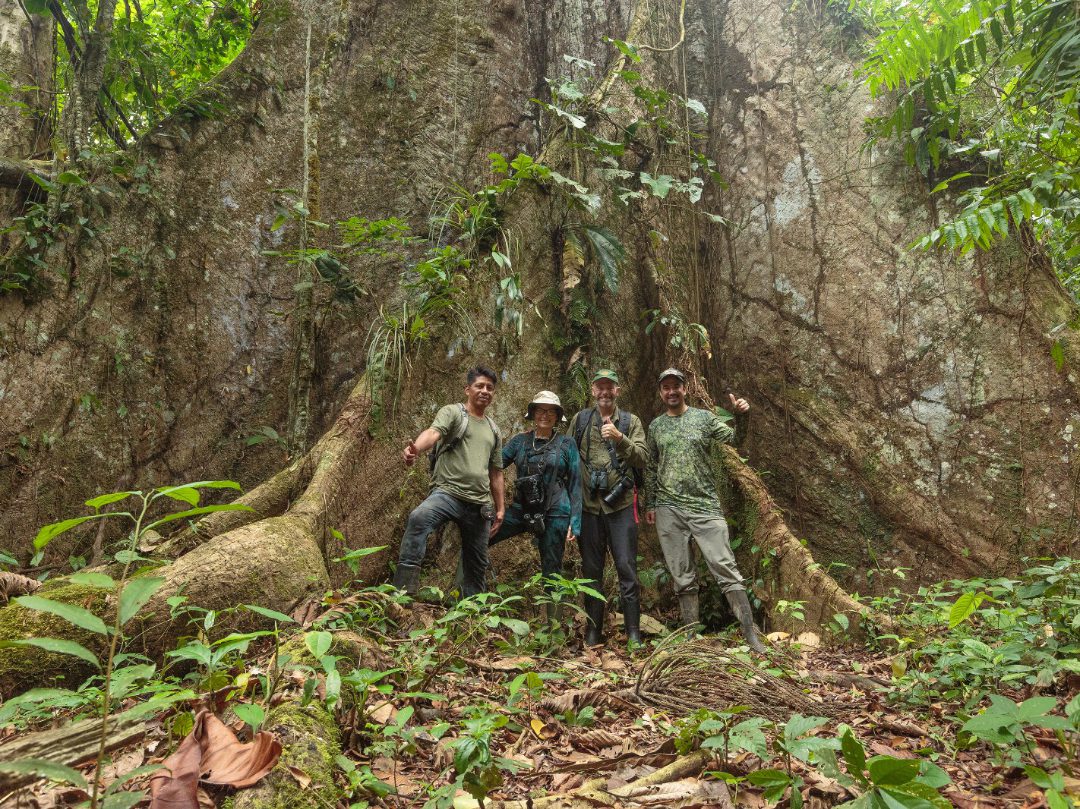 Scott and Angie standing with Humberto and Pablo in front of a huge Ceibo tree.