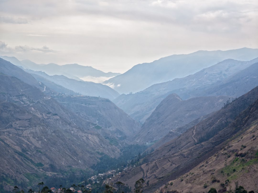 Mountain ranges disappear into the distance on a hazy day.