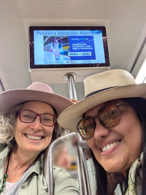 Two women smile for their selfie on the Quito Metro