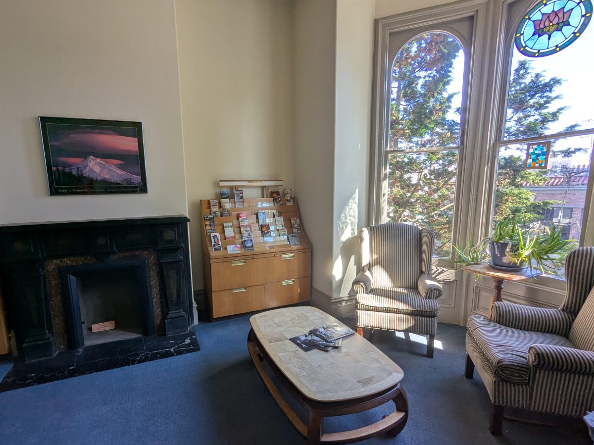 Sitting area near a picture window Cozy chairs next to big picture windows and a fireplace at the NW Portland Hostel.