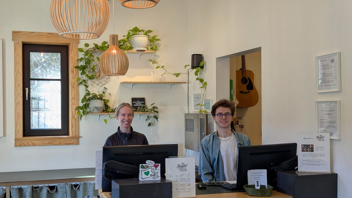 Staff with smiling faces wait to greet you at the Northwest Portland Hostel in Portland, Oregon.