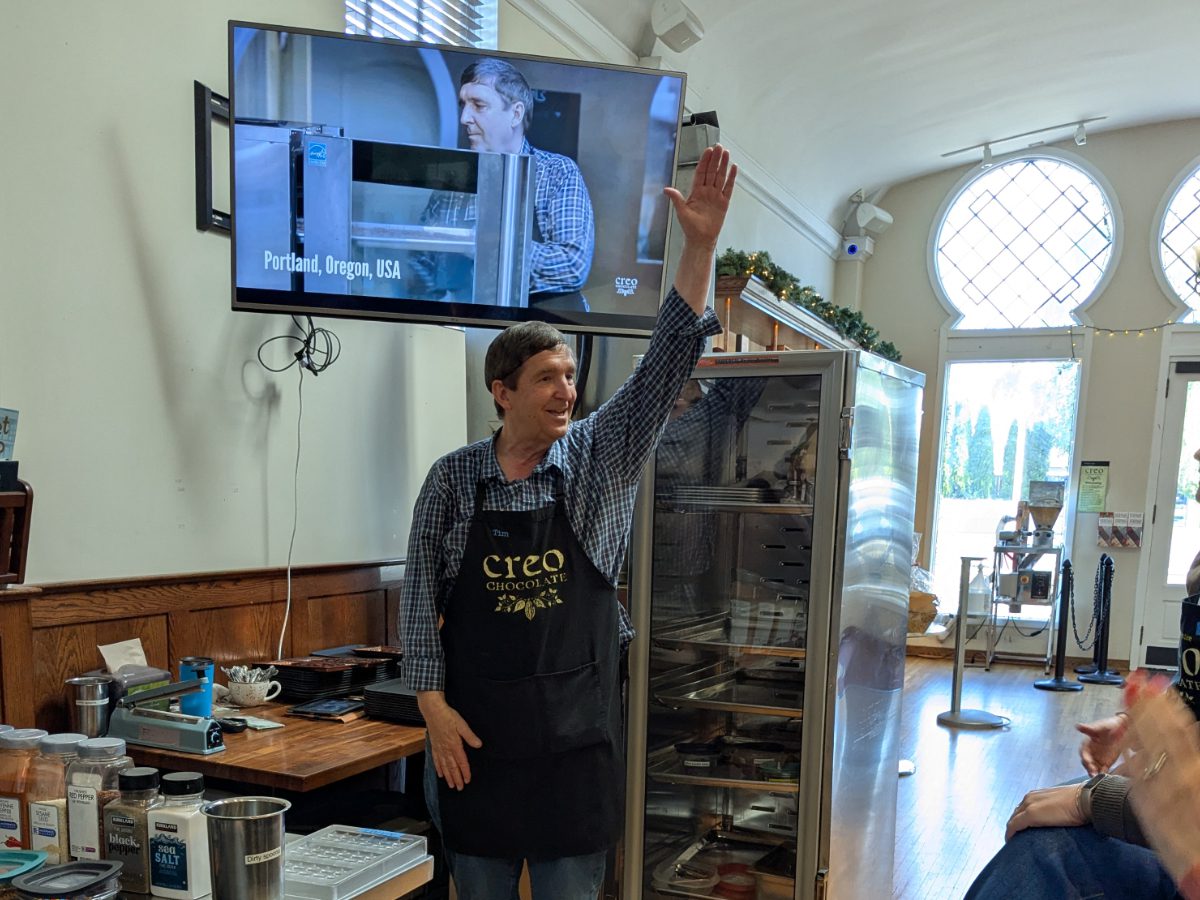 Tim Straub of Creo Chocolate Owner, Tim Straub, raises his hand as he asks a group of chocolate apprentices a question.