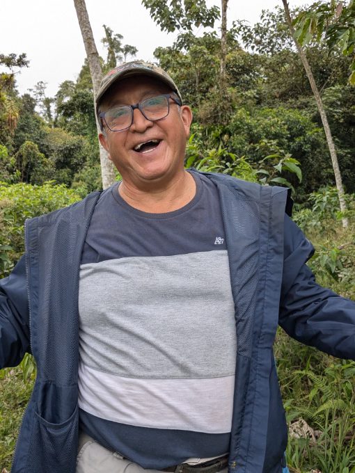 Jose Vega, smiling while talking, arms raised to clarify a point.