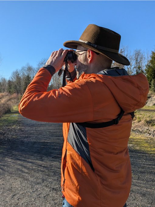 Scott wearing a Craft Sportswear Men's ADV Explore Lightweight Jacket while birdwatching on a sunny day in Oregon