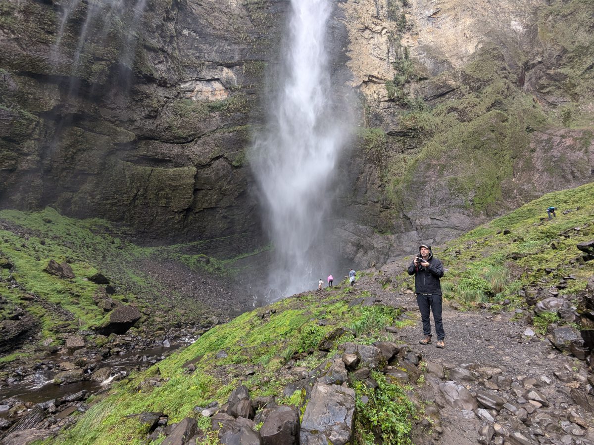 Scott at Gocta Falls, Amazonas, Peru Scott photographing the trail near the base of Gocta Waterfall in Amazonas, Peru, with the cascade falling behind him.