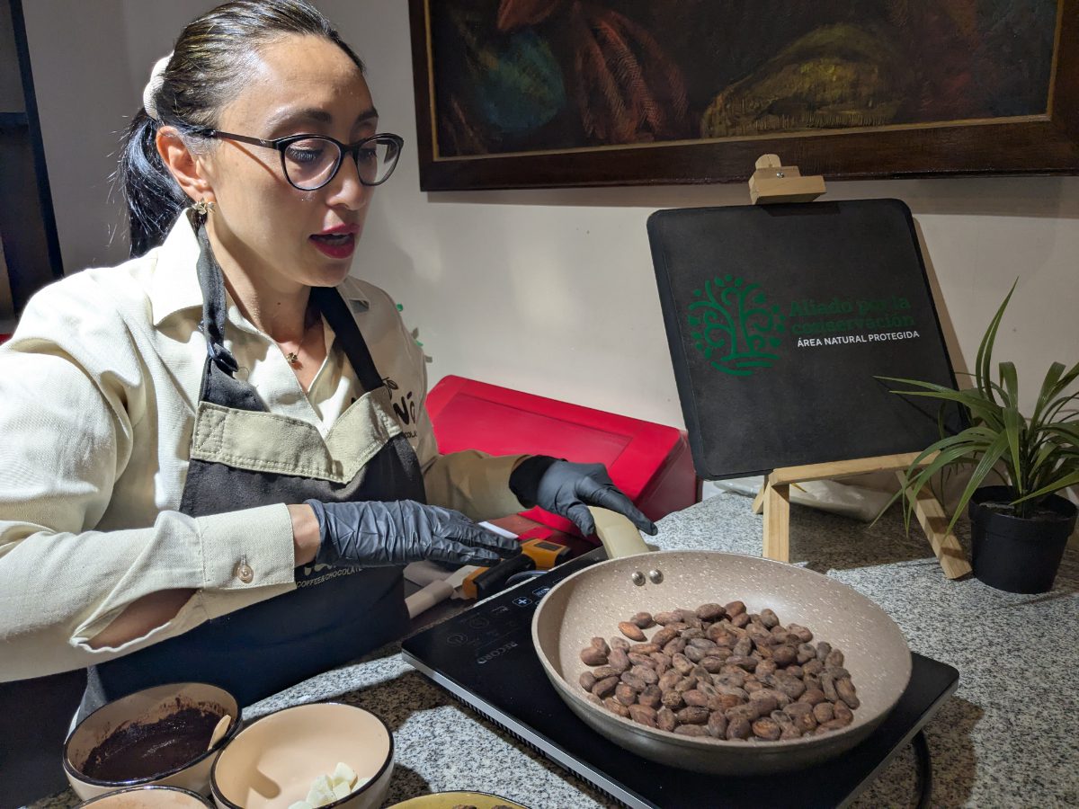Giannini toasts cacao beans in a small pan at Maná Chocolate.