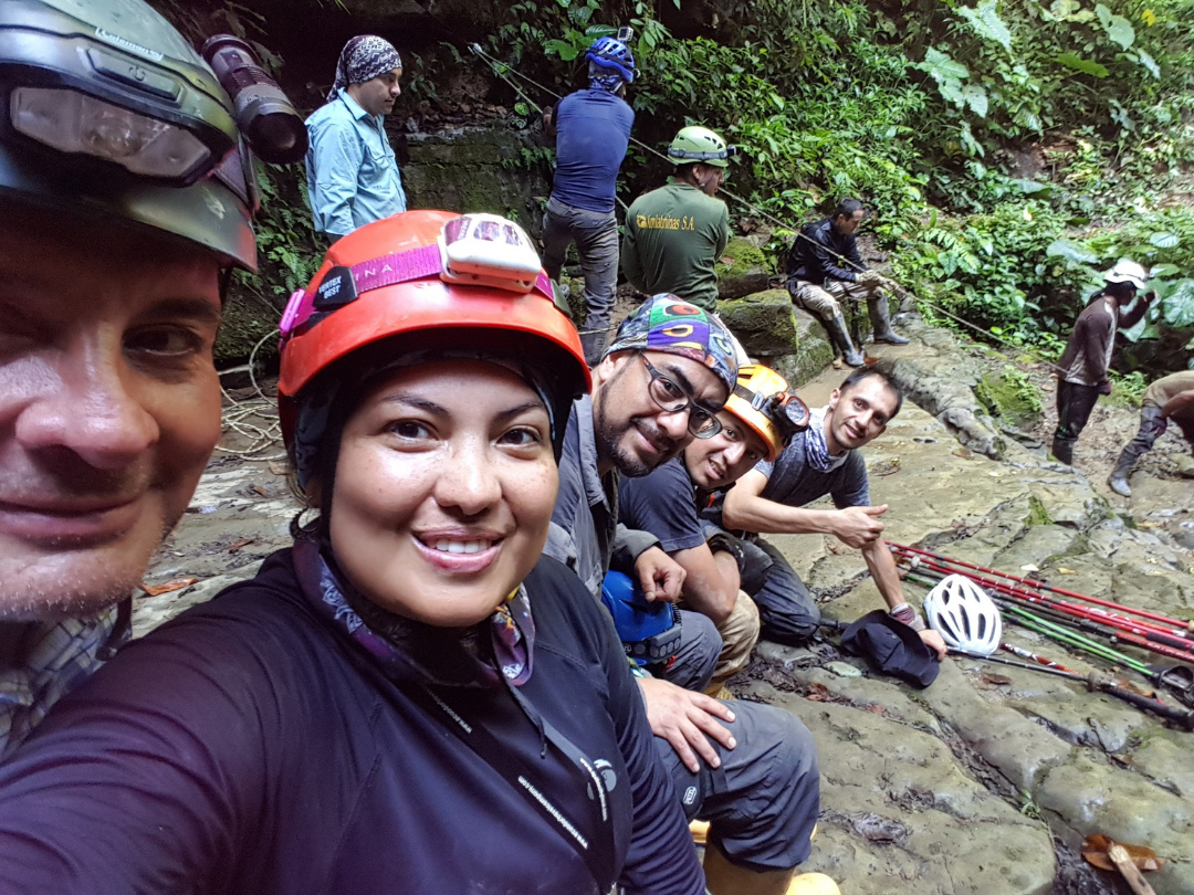 Selfie of Jacquie with friends descending through ropes into the Tayos cave.