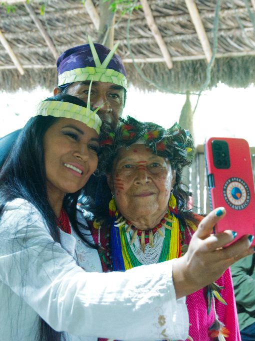 A Kichwa woman and her husband take a selfie with a Kichwa elder and local poet.