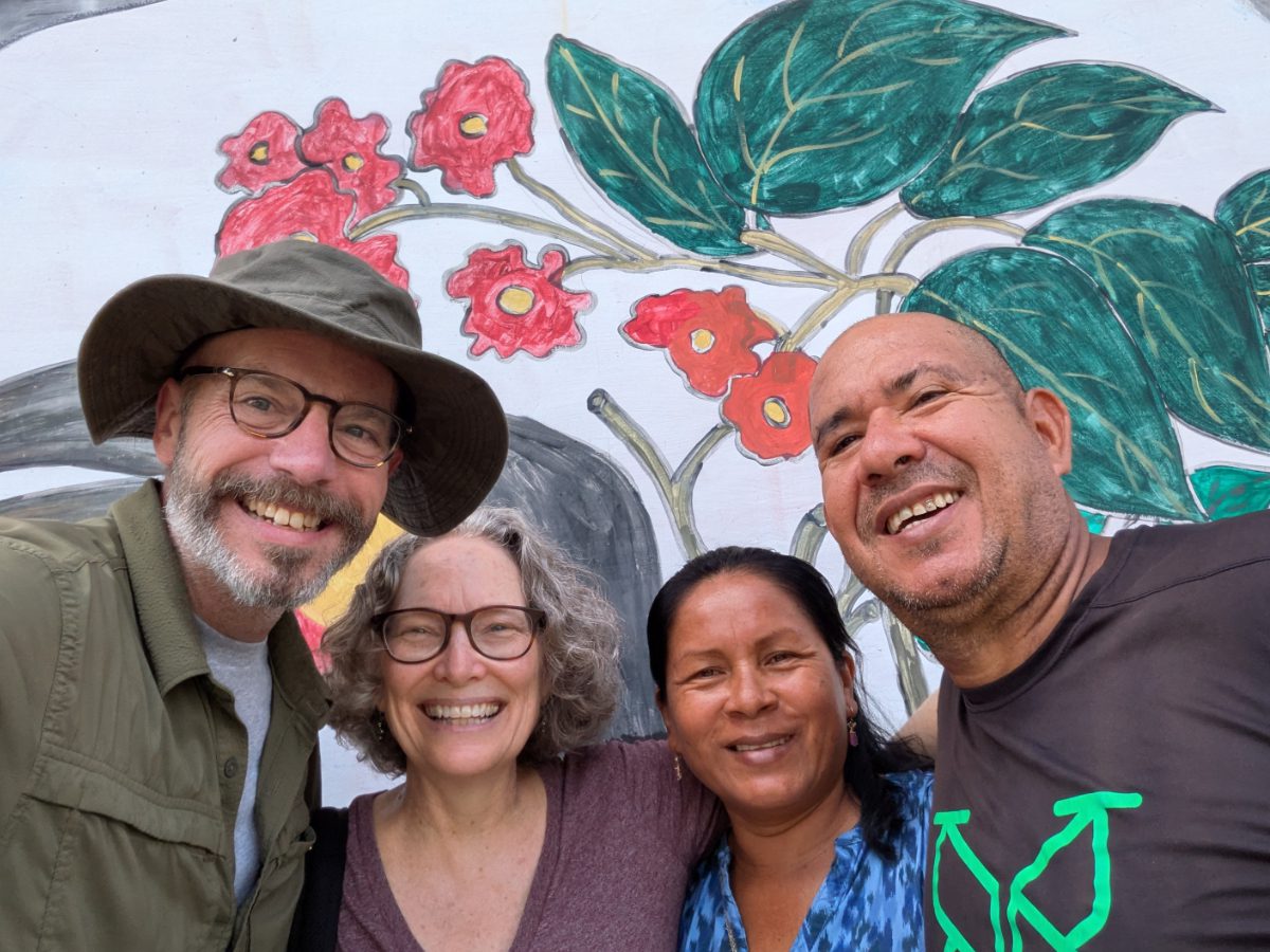 Two happy couples smile for a selfie. 