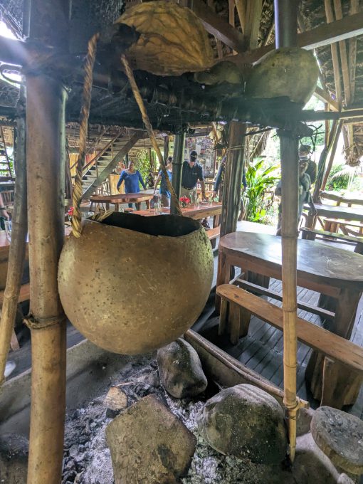 A gourd hangs above a smoldering fire pit in the dining room of Sinchi Warmi, Puero Misahualli, Ecuador