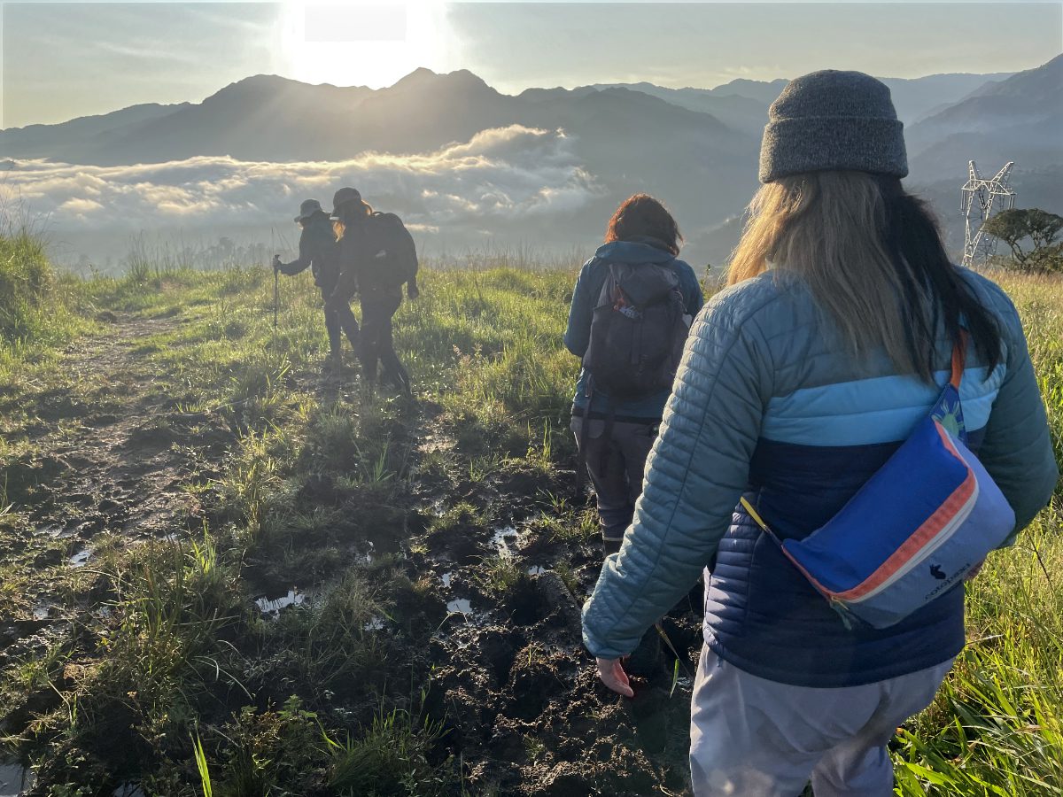 Women hiking as the sun rises over the Andes of Eastern Ecuador