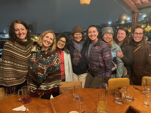 A group of women travelers towards smile for the camera.