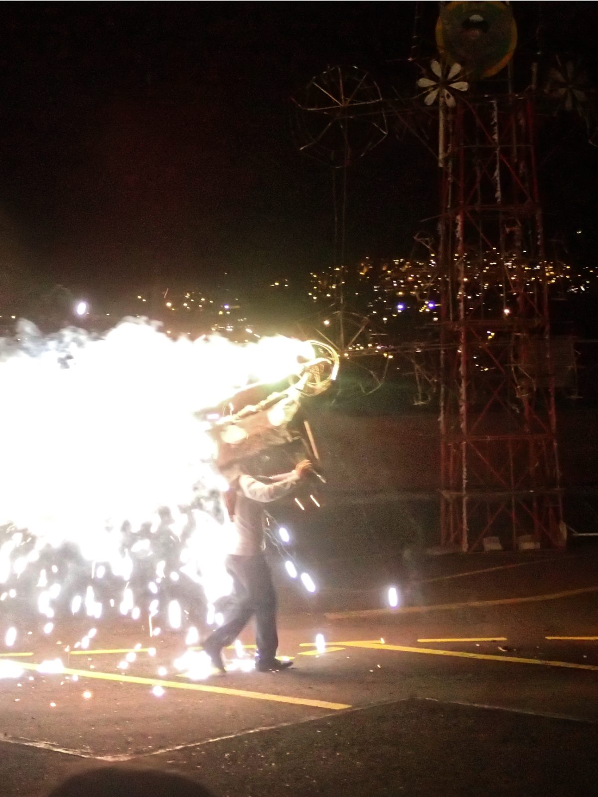 The Vaca Loca sprays white light on a dark night at a Fiestas de Quito celebration
