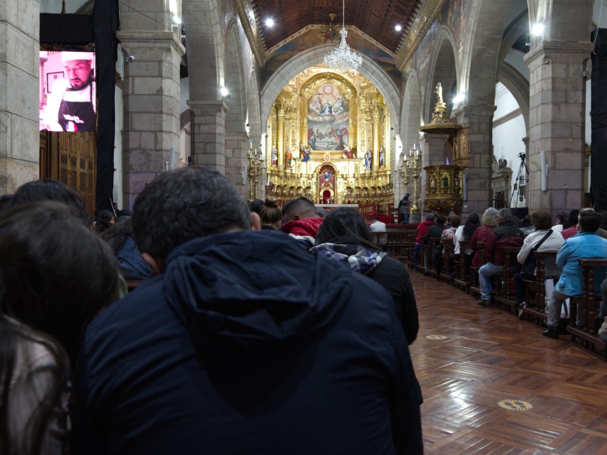 Sitting in the pews, it is possible to see the altar but the activity taking place except through the television screen on either side