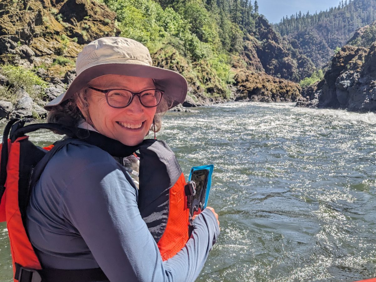 Angie smiles at the camera while preparing to raft Mule Creek Canyon