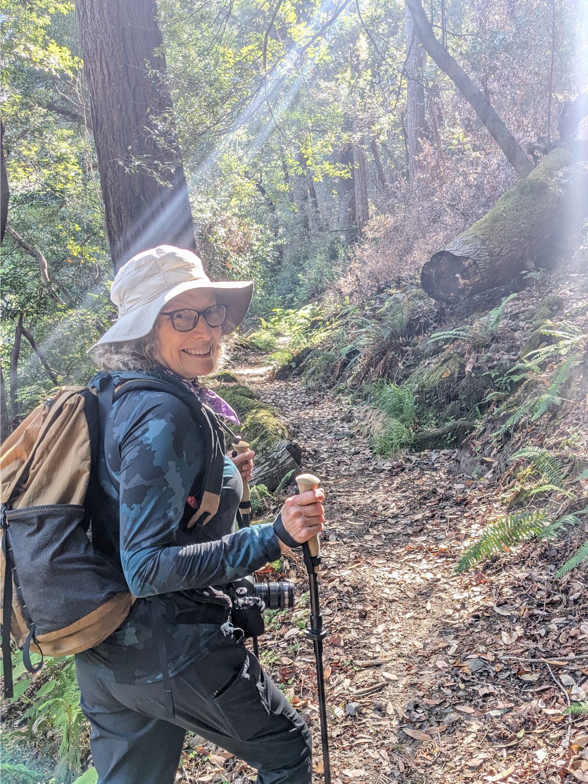 Angie dressed in full hiking gear as she takes off on a well maintained trail through the woods.
