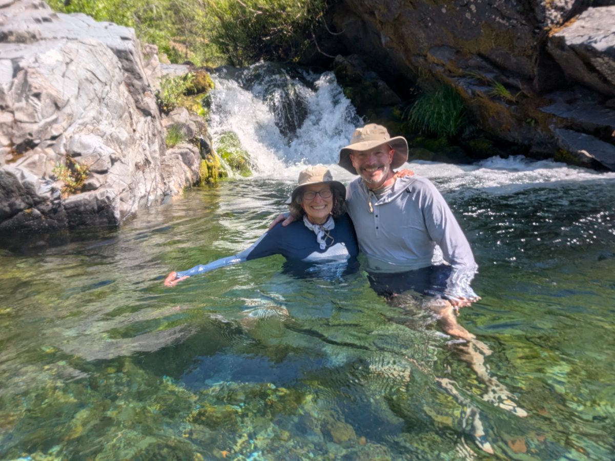 Scott and Angie pose while standing in the cold water pool formed where Howard Creek meets the Rogue River