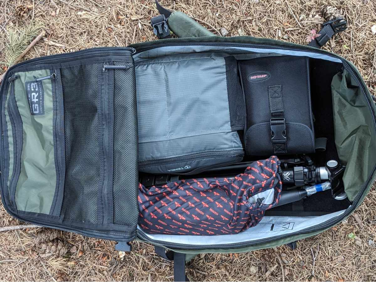 The GORUCK GR# zipped open to show it packed with spotting scope, binoculars, tripod, and camera gear.