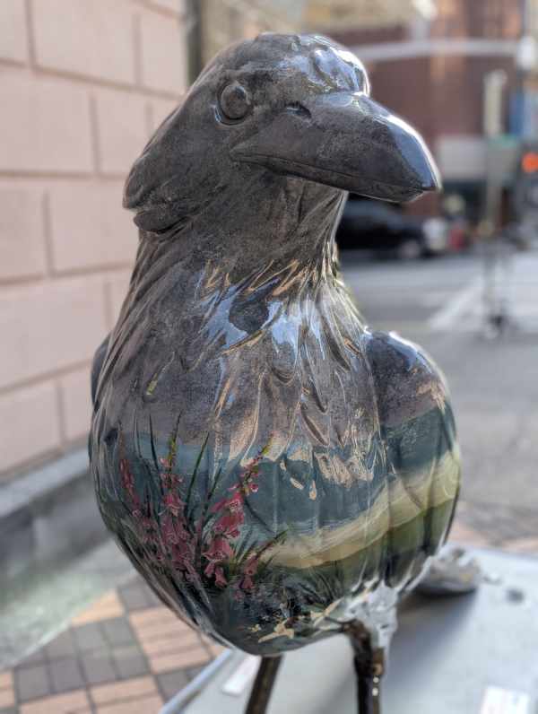 Front view of Oregon Botanica, a crow sculpture with foxglove painted on the crows belly.