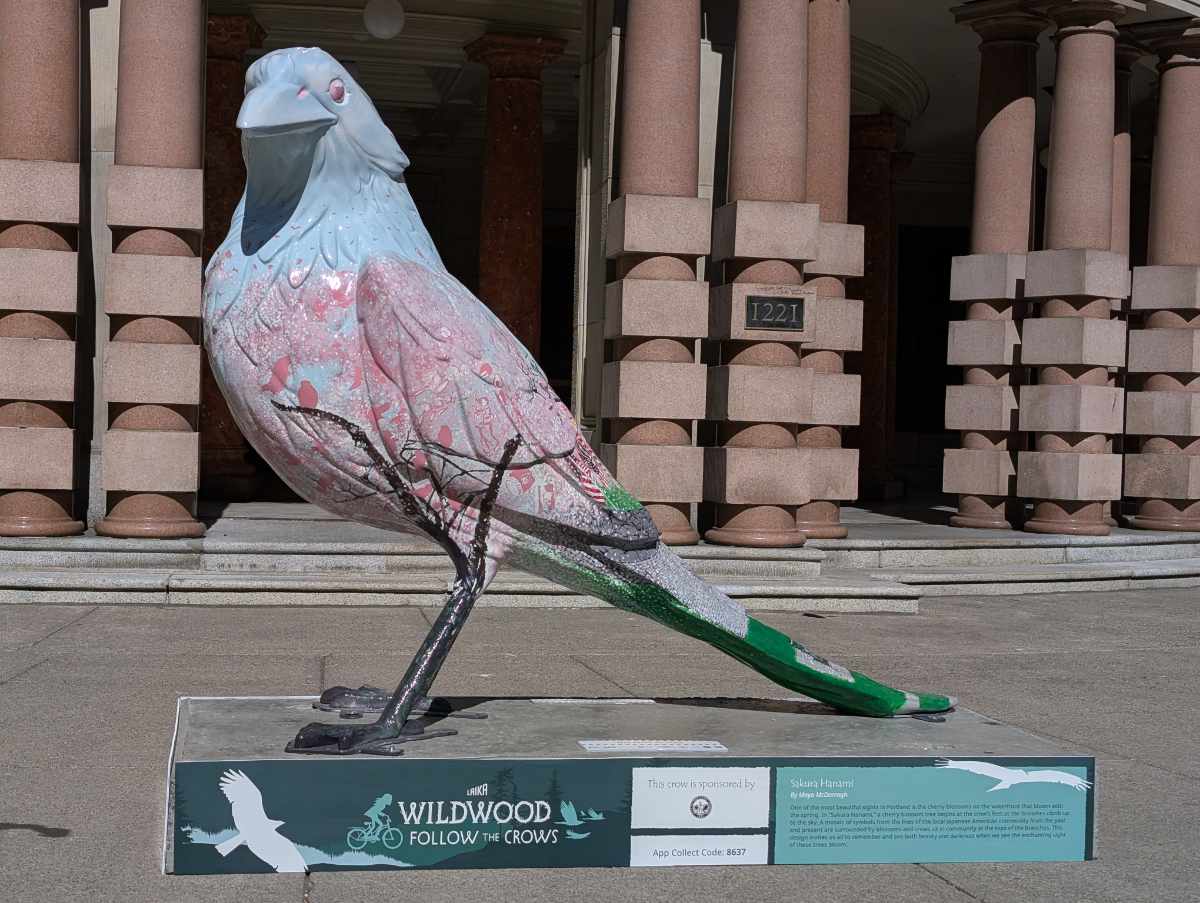 The pink and blue statue titled Sakura Hanami, part of the Follow the Crows trail, stands before Portland City Hall.