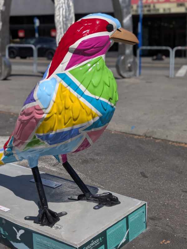 The Shape of Us sculpture is painted in blocks of hot pink, lime green, sky blue, turquoise, sunflower yellow and more.